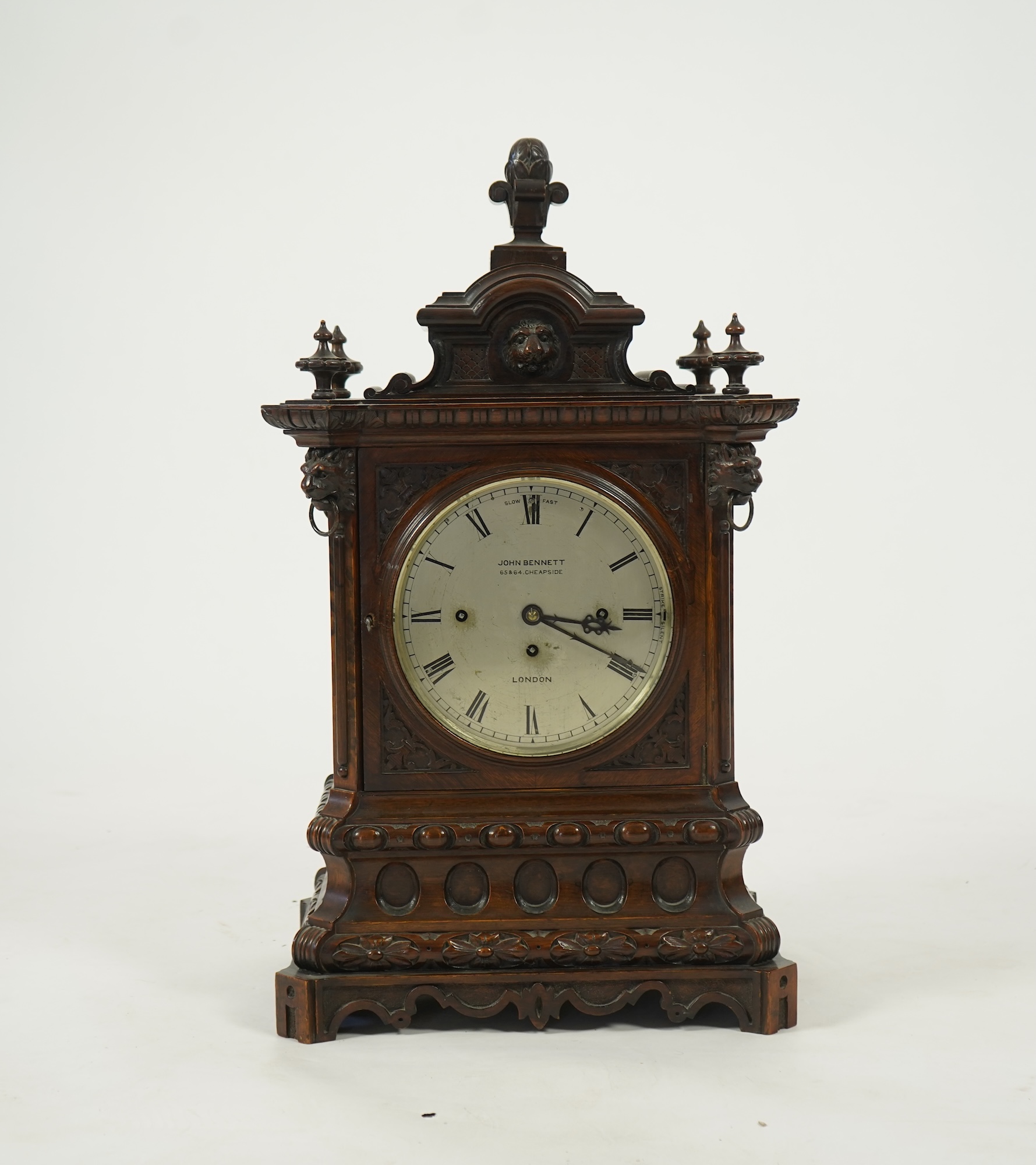 A late 19th century carved oak triple fusee bracket clock